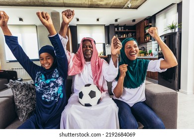 Arab Man Looking TV At Home During A Sport Event With His Family. Watching Football Game.