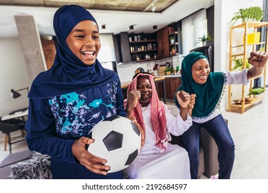 Arab Man Looking TV At Home During A Sport Event With His Family. Watching Football Game.