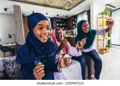 Arab Man Looking TV At Home During A Sport Event With His Family. Watching Football Game.