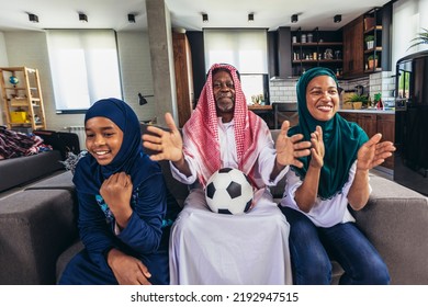 Arab Man Looking TV At Home During A Sport Event With His Family. Watching Football Game.