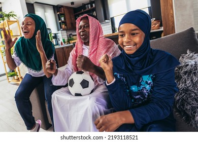 Arab Man Looking TV At Home During A Sport Event With His Family. Watching Football Game.