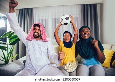 Arab Man Looking TV At Home During A Sport Event With His Family. Watching Football Game.