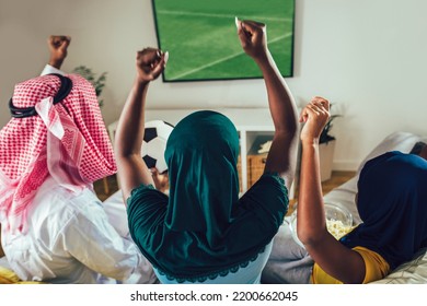 Arab Man Looking TV At Home During A Sport Event With His Family. Watching Football Game.