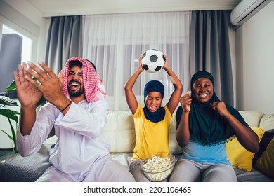 Arab Man Looking TV At Home During A Sport Event With His Family. Watching Football Game.