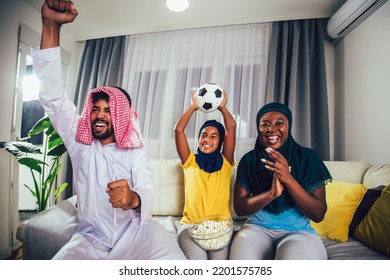 Arab Man Looking TV At Home During A Sport Event With His Family. Watching Football Game.