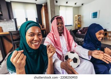 Arab Man Looking TV At Home During A Sport Event With His Family. Watching Football Game.
