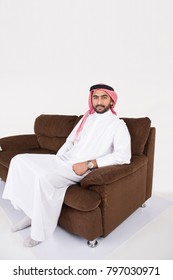 Arab Man Sitting On Sofa Chair At Home With White Background