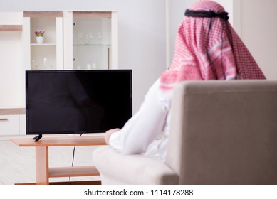 Arab Man Watching Tv At Home