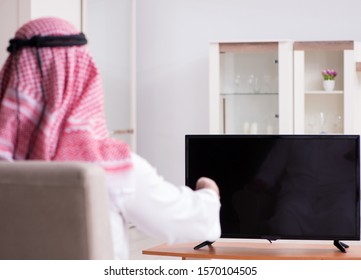 Arab Man Watching Tv At Home