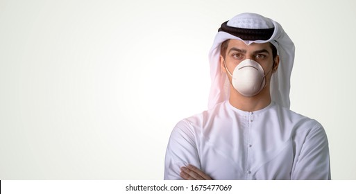 Arab man wearing medical face mask protecting himself from coronavirus,
isolated on the background.