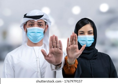 Arab man and woman with face medical mask showing stop gesture. People, healthcare and medicine concept