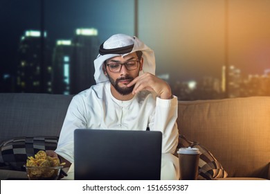 Arab Man Working Late From Home Sitting On Sofa Night Time 