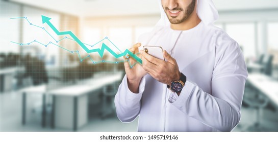 Arab Man Working With Smartphone In The Office. Business And Finance Concept.