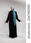 Arab middle eastern Saudi woman in hijab and traditional formal Abaya, on white isolated background, with different poses, expressions, hand and gestures