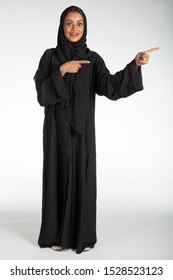 Arab Middle Eastern Saudi Woman In Traditional Formal Abaya, On White Isolated Background, With Different Poses, Expressions, Hand And Gestures, Studio Lighting Ready For Cutout And Editing.