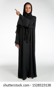 Arab Middle Eastern Saudi Woman In Traditional Formal Abaya, On White Isolated Background, With Different Poses, Expressions, Hand And Gestures, Studio Lighting Ready For Cutout And Editing.