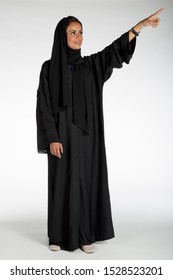 Arab Middle Eastern Saudi Woman In Traditional Formal Abaya, On White Isolated Background, With Different Poses, Expressions, Hand And Gestures, Studio Lighting Ready For Cutout And Editing.