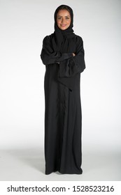 Arab middle eastern Saudi woman in traditional formal Abaya, on white isolated background, with different poses, expressions, hand and gestures, studio lighting ready for cutout and editing.