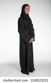 Arab Middle Eastern Saudi Woman In Traditional Formal Abaya, On White Isolated Background, With Different Poses, Expressions, Hand And Gestures, Studio Lighting Ready For Cutout And Editing.