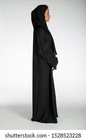 Arab Middle Eastern Saudi Woman In Traditional Formal Abaya, On White Isolated Background, With Different Poses, Expressions, Hand And Gestures, Studio Lighting Ready For Cutout And Editing.