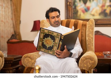 Arab Muslim man reading the holy book the Quran Kareem
