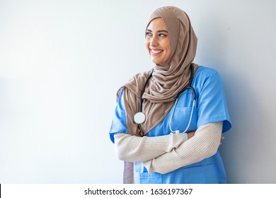 Arab Nurse Woman Wearing Hijab Over Isolated Background Looking Away To Side With Smile On Face, Natural Expression. Laughing Confident. Authentic Confident Middle Eastern Healthcare Worker