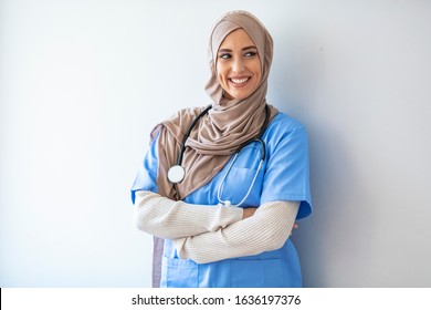 Arab Nurse Woman Wearing Hijab Over Isolated Background Looking Away To Side With Smile On Face, Natural Expression. Laughing Confident. Authentic Confident Middle Eastern Healthcare Worker