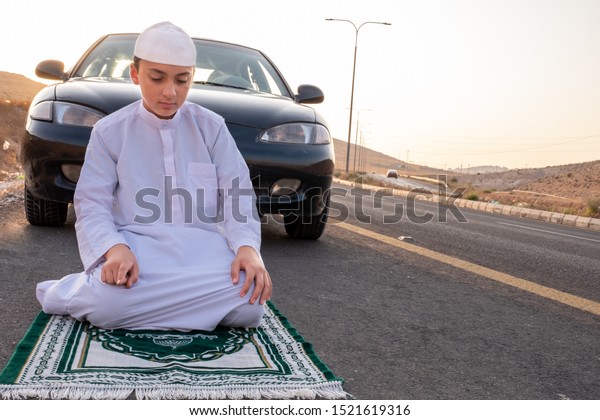 Arab people\
outside praying for god in the\
nature