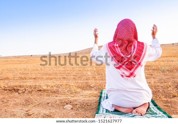 Arab people
outside praying for god in the
nature