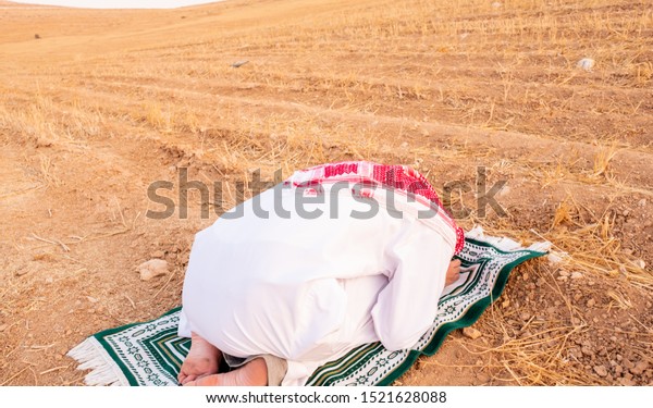 Arab people\
outside praying for god in the\
nature