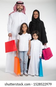 Arab Saudi Family At The Mall With Colored Shopping Bags, On White Isolated Background, Ready For Cutout And Design Purposes.