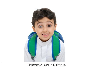 Arab School Boy Closeup On Face With A Smile And Broken Tooth, Wearing White Traditional Saudi Thobe, Back Pack And Sneakers, Raising His Hands On White Isolated Background