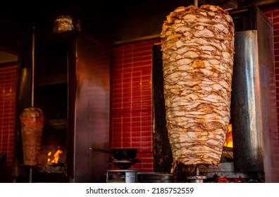 Arab Shawarma Of Meat Chicken Preparation Placed On Spit Grilled With Burn.