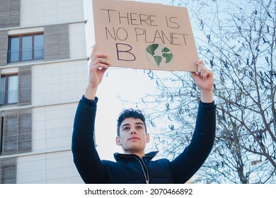 Arab teenager with climate change banner on environment demonstration, COP 27 Climate Change Conference