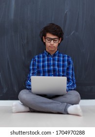 Arab Teenager Using Laptop To Work On Homework And Watch Online Education While Staying At Home Cause Coronavirus Pandemic Quarantine