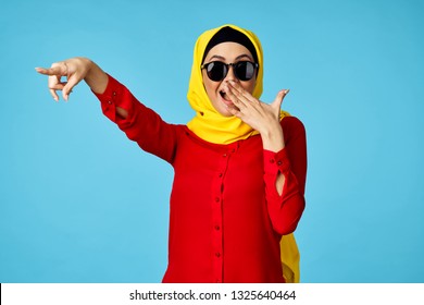  arab woman in burqa on blue background                             - Shutterstock ID 1325640464