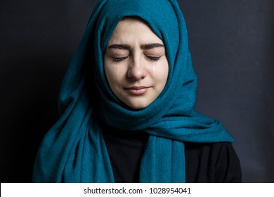 An Arab woman is crying. Portrait of a Muslim girl with tears in her eyes.  - Shutterstock ID 1028954041