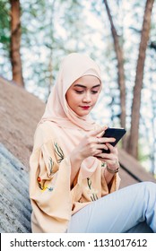 Arab Woman Dialing Phone Number Using Cell Phone Outside Office.