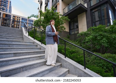 Arab woman in national dress descends the stairs