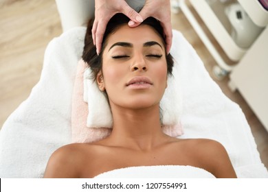 Arab woman receiving head massage in spa wellness center. Beauty and Aesthetic concepts. - Powered by Shutterstock