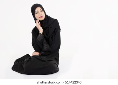 Arab Woman Sitting On The Floor Isolated On White Background