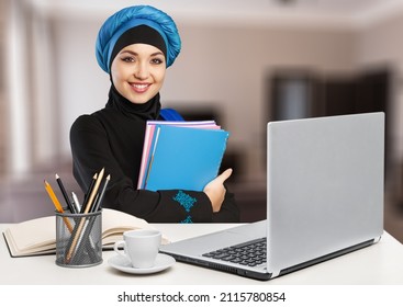 Arab At Work. Emirati Woman Using Computer Typing. Girl In Abaya And Hijab