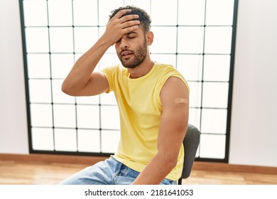 Arab Young Man Getting Vaccine Showing Arm With Band Aid Stressed And Frustrated With Hand On Head, Surprised And Angry Face 