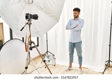 Arab Young Man Posing As Model At Photography Studio Skeptic And Nervous, Disapproving Expression On Face With Crossed Arms. Negative Person. 