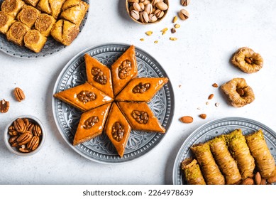 Arabian Baklava with nuts and honey on white background, top view. Ramadan dessert - fresh assorted nut baklava. - Shutterstock ID 2264978639