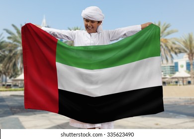 Arabian Boy Holding UAE Flag Outdoors