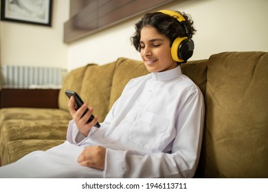 Arabian Boy At Home With Headphones And Mobile 