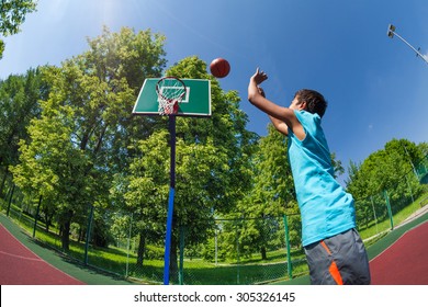 Arabian Boy Throws Ball In Basketball Goal