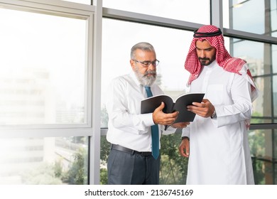 Arabian Business man with a Middle aged businessman discussing work in a modern office 