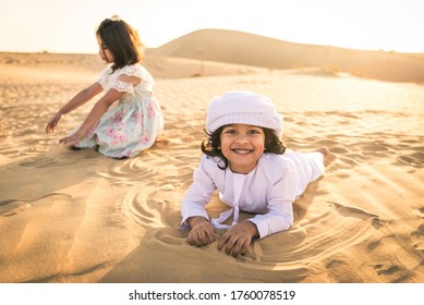 Arabian Family With Kids Having Fun In The Desert - Parents And Children Celebrating Holiday In The Dubai Desrt